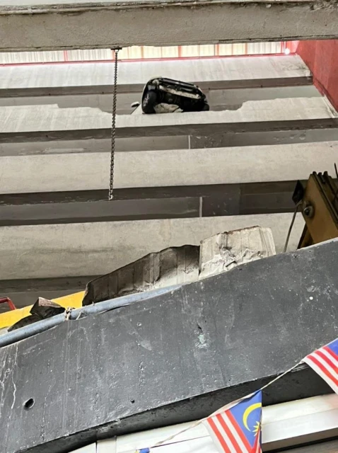 邁威失控撞破停車場圍牆　墜落碎石砸傷婦女