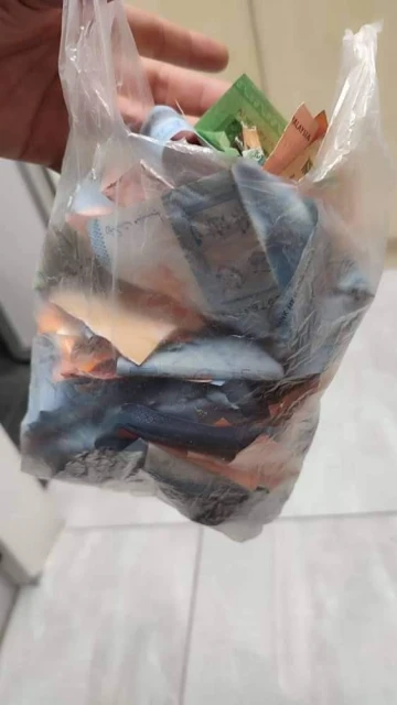 流浪漢撕破一堆鈔票丟馬路　女子撿起粘好拿去幫有需要者