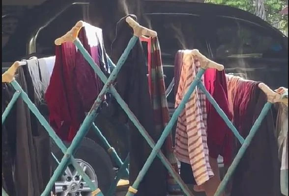 婦女烈陽下曬衣服　驚見衣服冒煙